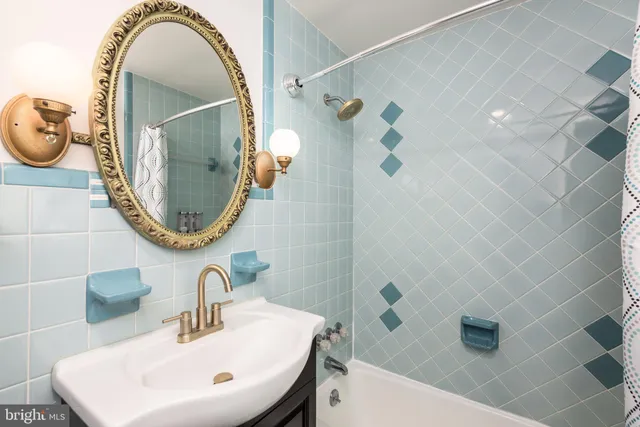 a bathroom with a sink a mirror and a mirror