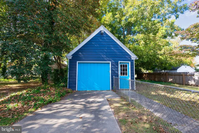 a view of a house with a yard next to a house
