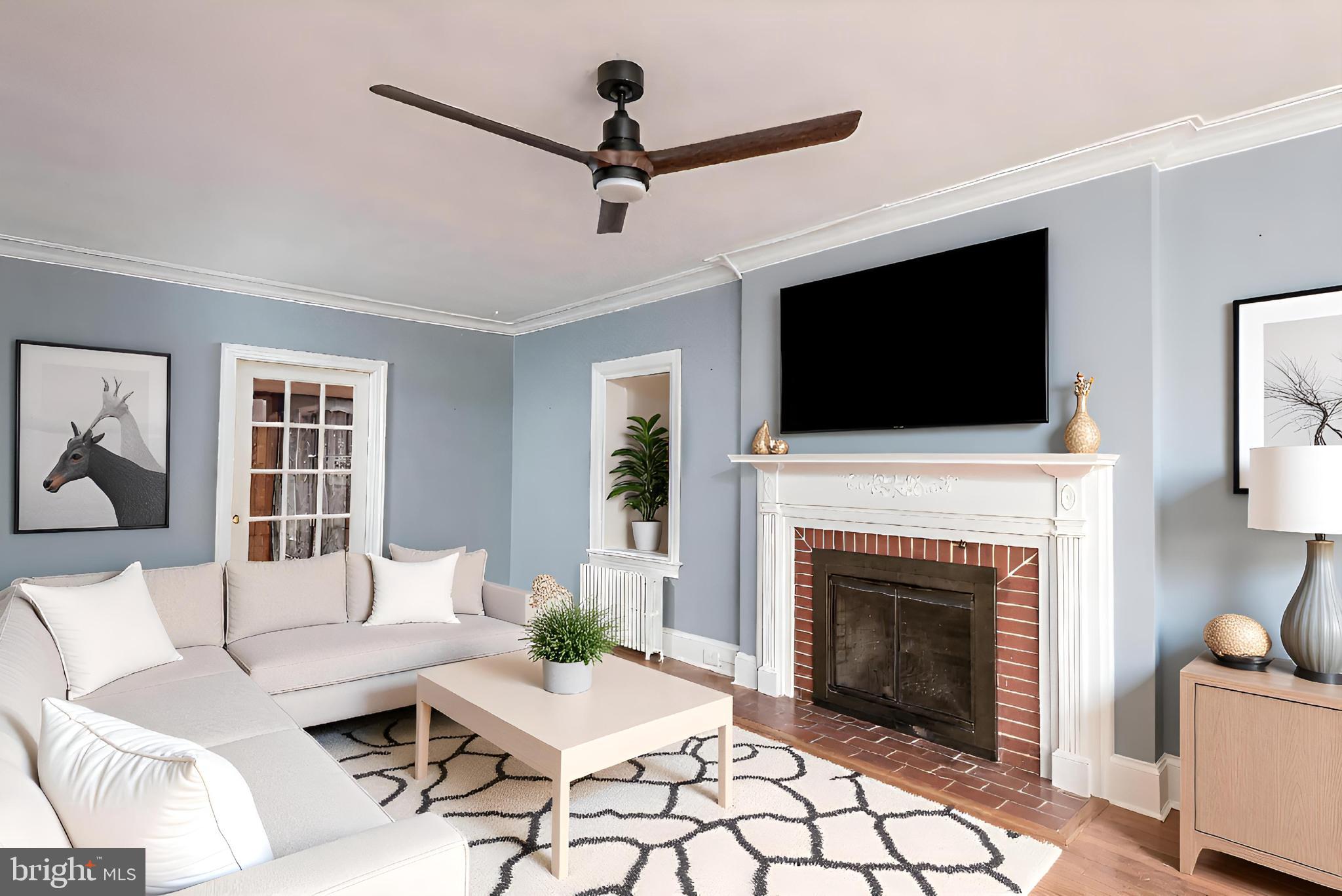 107 Rambler Road Cambridge, MD 21613 - Photo 8 of 28 a living room with furniture a fireplace and a flat screen tv