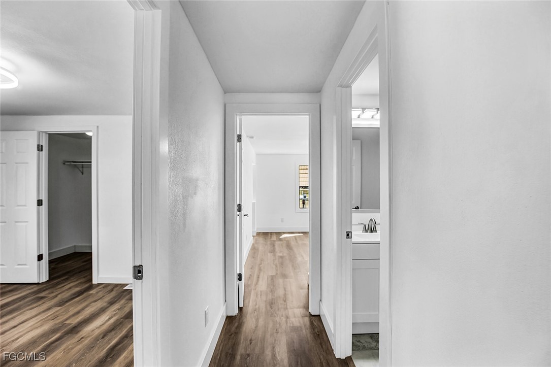13651 Grackle Road Fort Myers, FL 33908 - Photo 21 of 43 a view of a hallway with wooden floor and staircase