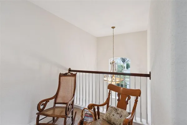 a view of a hallway with furniture