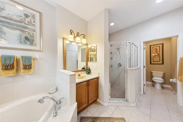 a spacious bathroom with a granite countertop tub sink and mirror