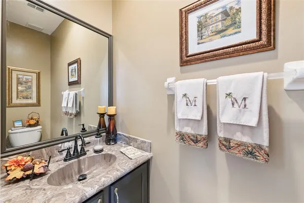 a bathroom with a sink vanity and mirror