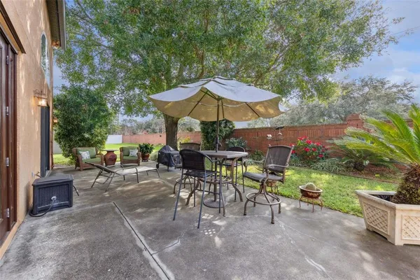 an outdoor space with patio and white umbrellas