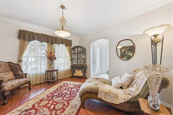a living room with furniture a bed and a chandelier