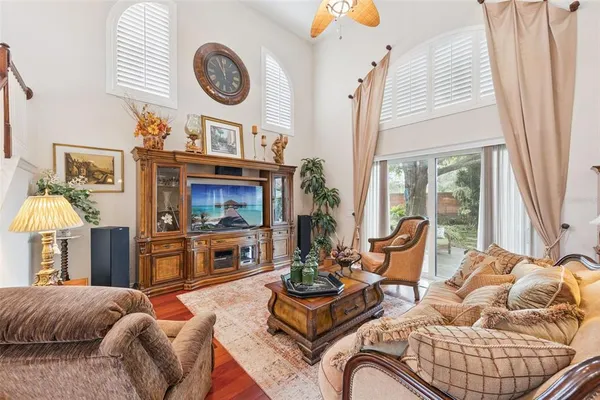 a living room with furniture a flat screen tv and a fireplace