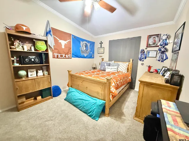 a bedroom with a bed and with on the wall in it