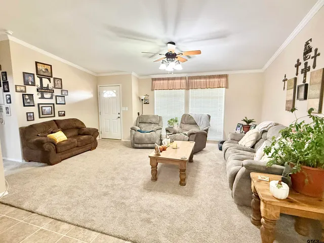 a living room with furniture and a chandelier