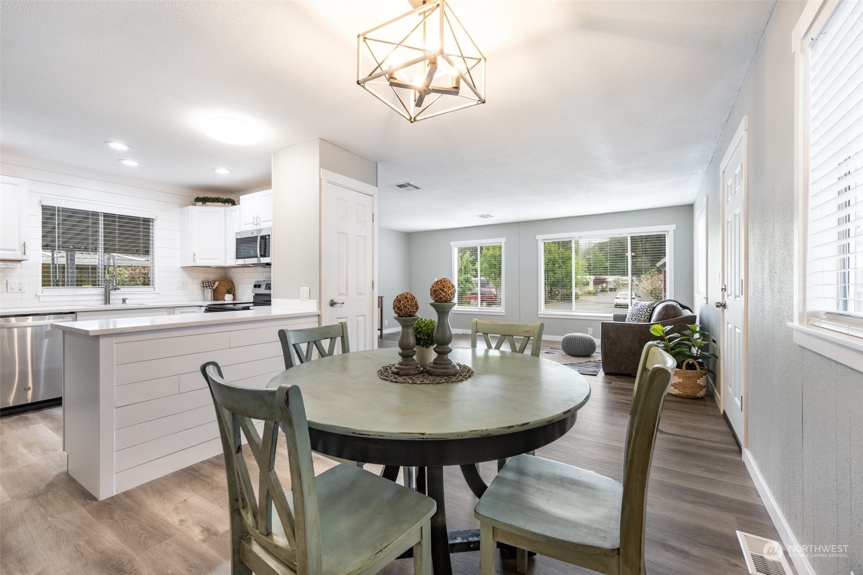2302 R Street Southeast, Unit 12 Auburn, WA 98002 - Photo 13 of 34 a view of a dining room with furniture and wooden floor