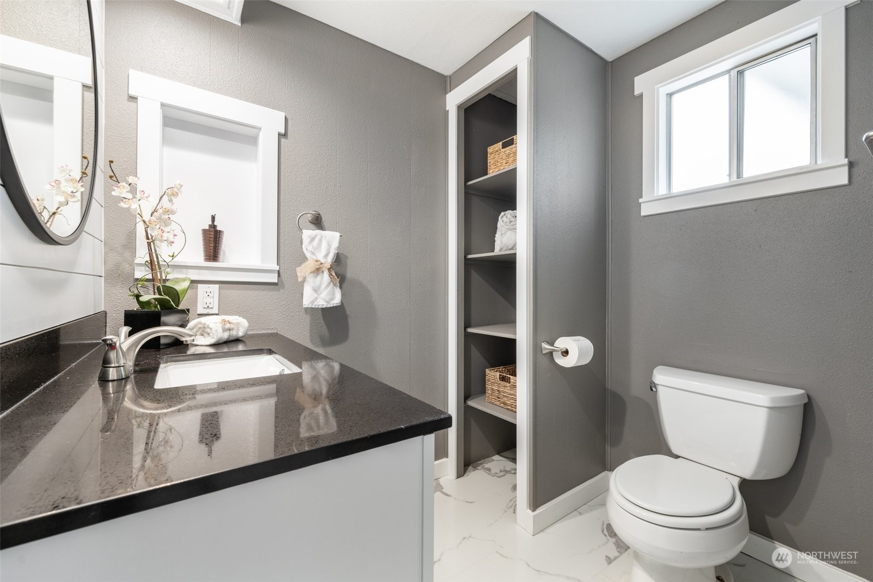 2302 R Street Southeast, Unit 12 Auburn, WA 98002 - Photo 19 of 34 a bathroom with a toilet a sink and a mirror
