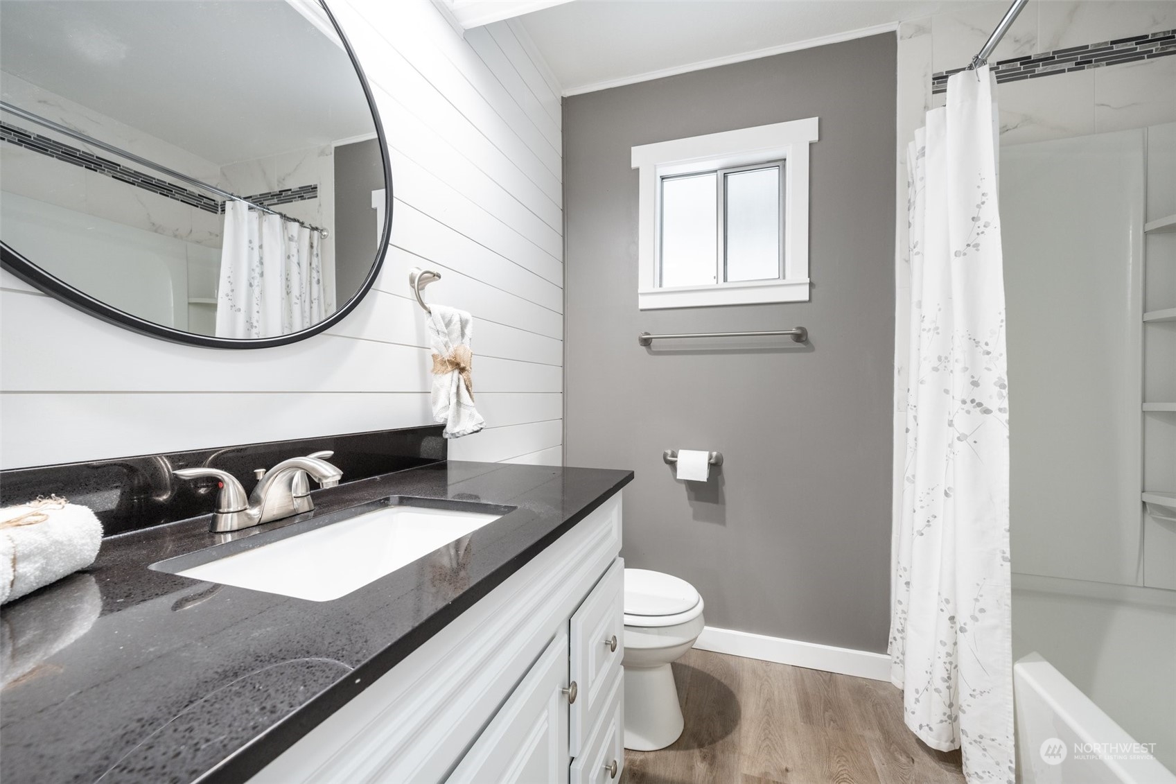 2302 R Street Southeast, Unit 12 Auburn, WA 98002 - Photo 21 of 34 a bathroom with a granite countertop sink mirror toilet and vanity