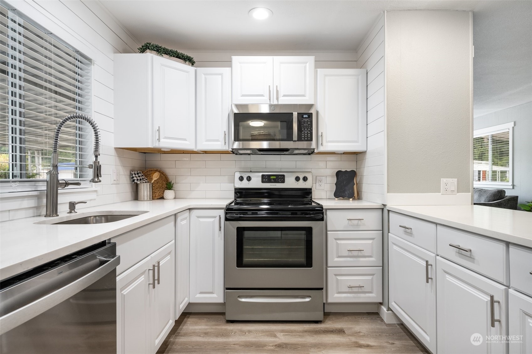 2302 R Street Southeast, Unit 12 Auburn, WA 98002 - Photo 7 of 34 a kitchen with white cabinets stainless steel appliances and sink