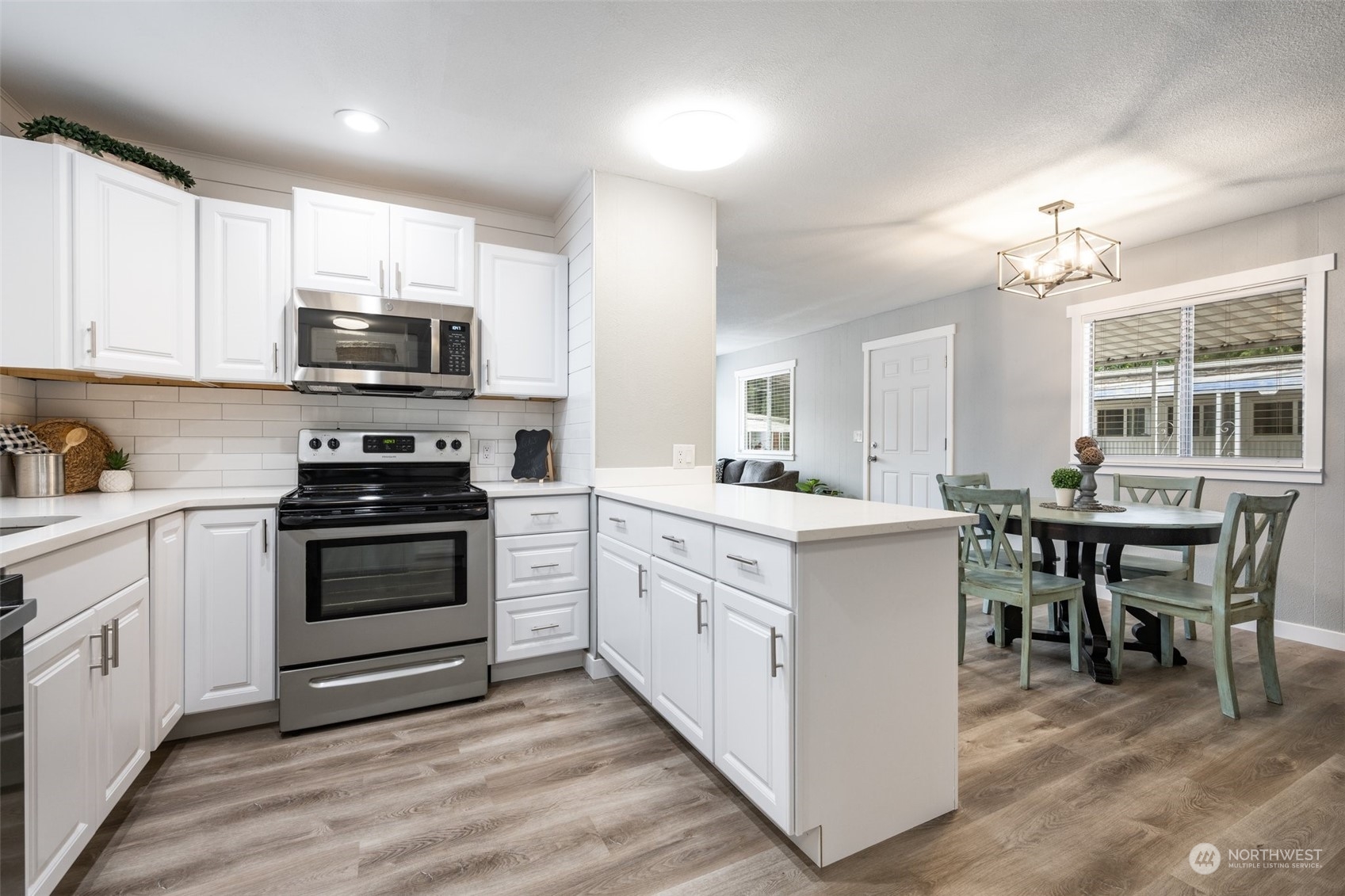 2302 R Street Southeast, Unit 12 Auburn, WA 98002 - Photo 9 of 34 a kitchen with white cabinets and appliances