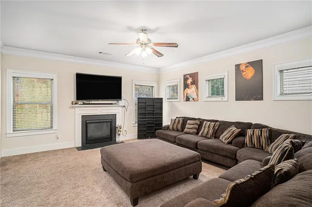 a living room with furniture a flat screen tv and a fireplace