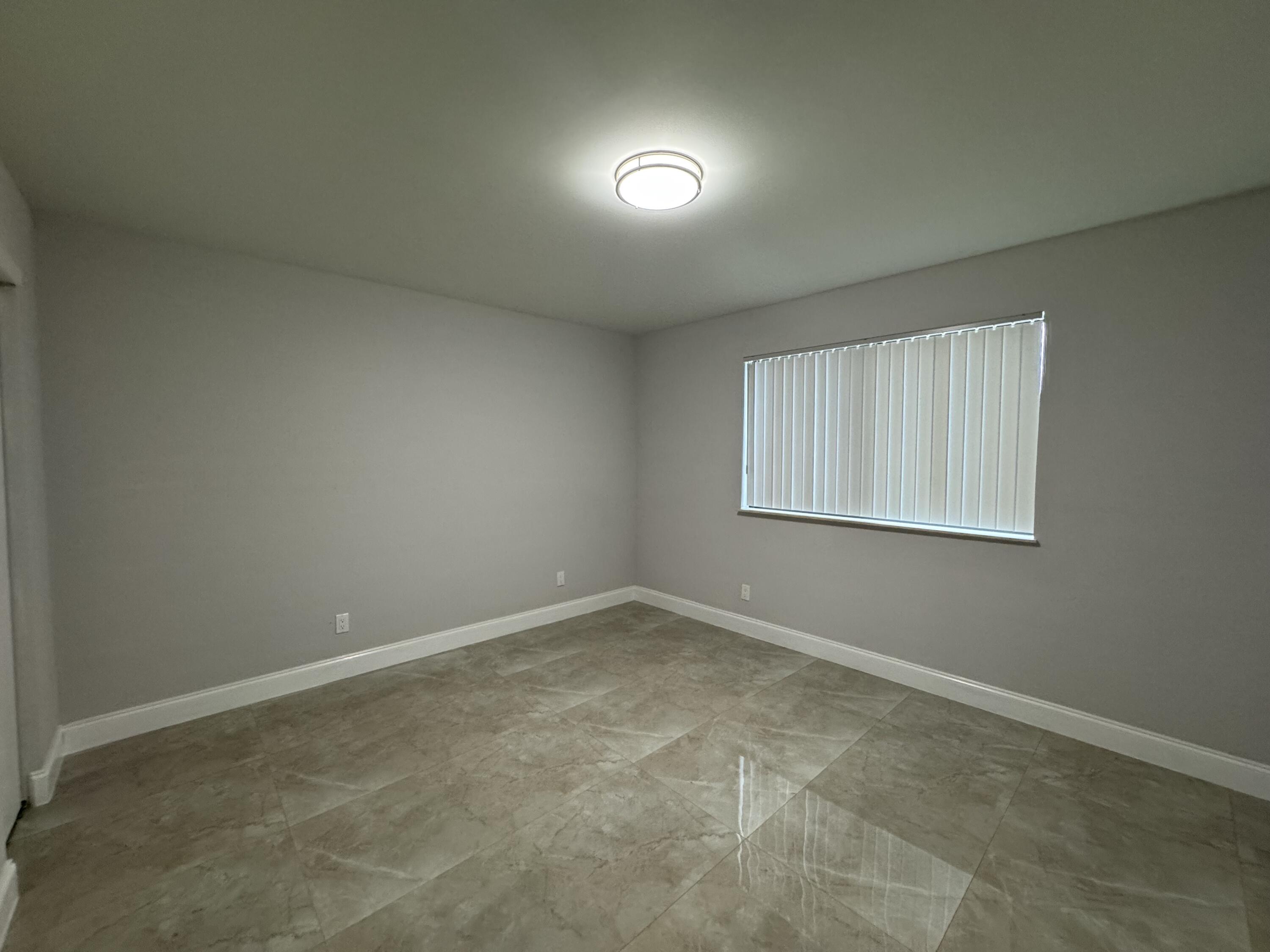 400 Northeast 30th Street, Unit 2 Pompano Beach, FL 33064 - Photo 15 of 22 an empty room with a empty space and window
