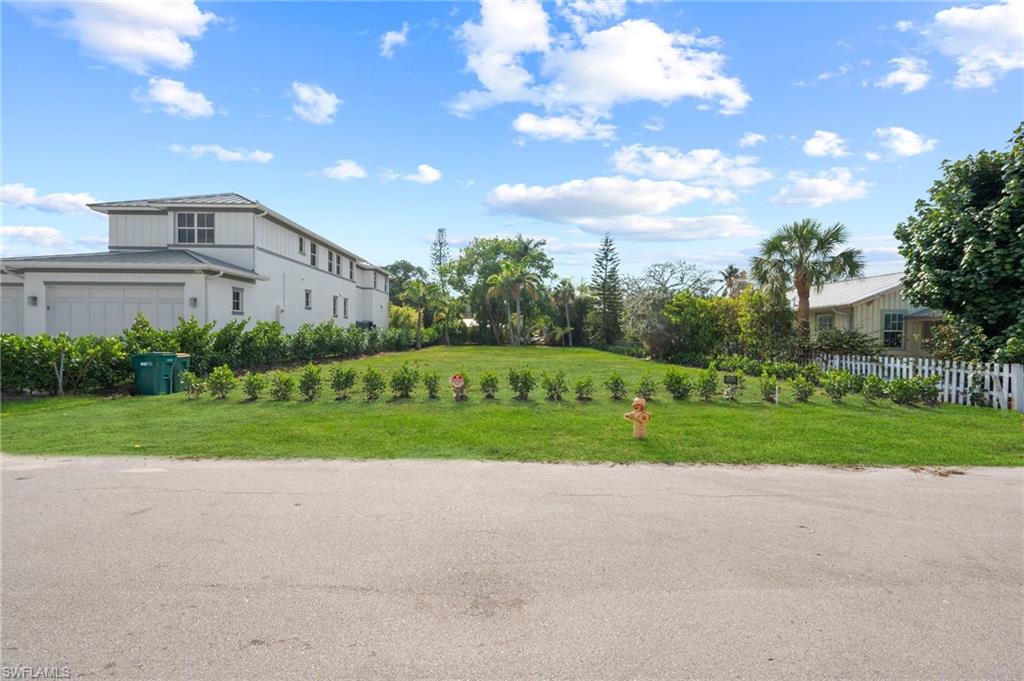 1972 Frederick Street Naples, FL 34112 - Photo 5 of 14 a view of a house with a big yard and a large trees