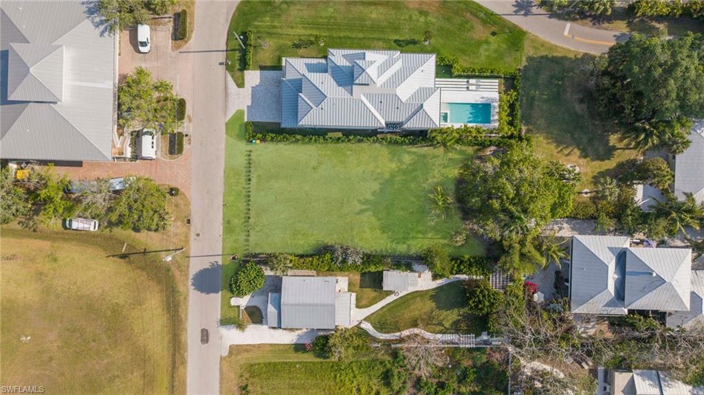 1972 Frederick Street Naples, FL 34112 - Photo 10 of 14 an aerial view of a house with a garden and lake view