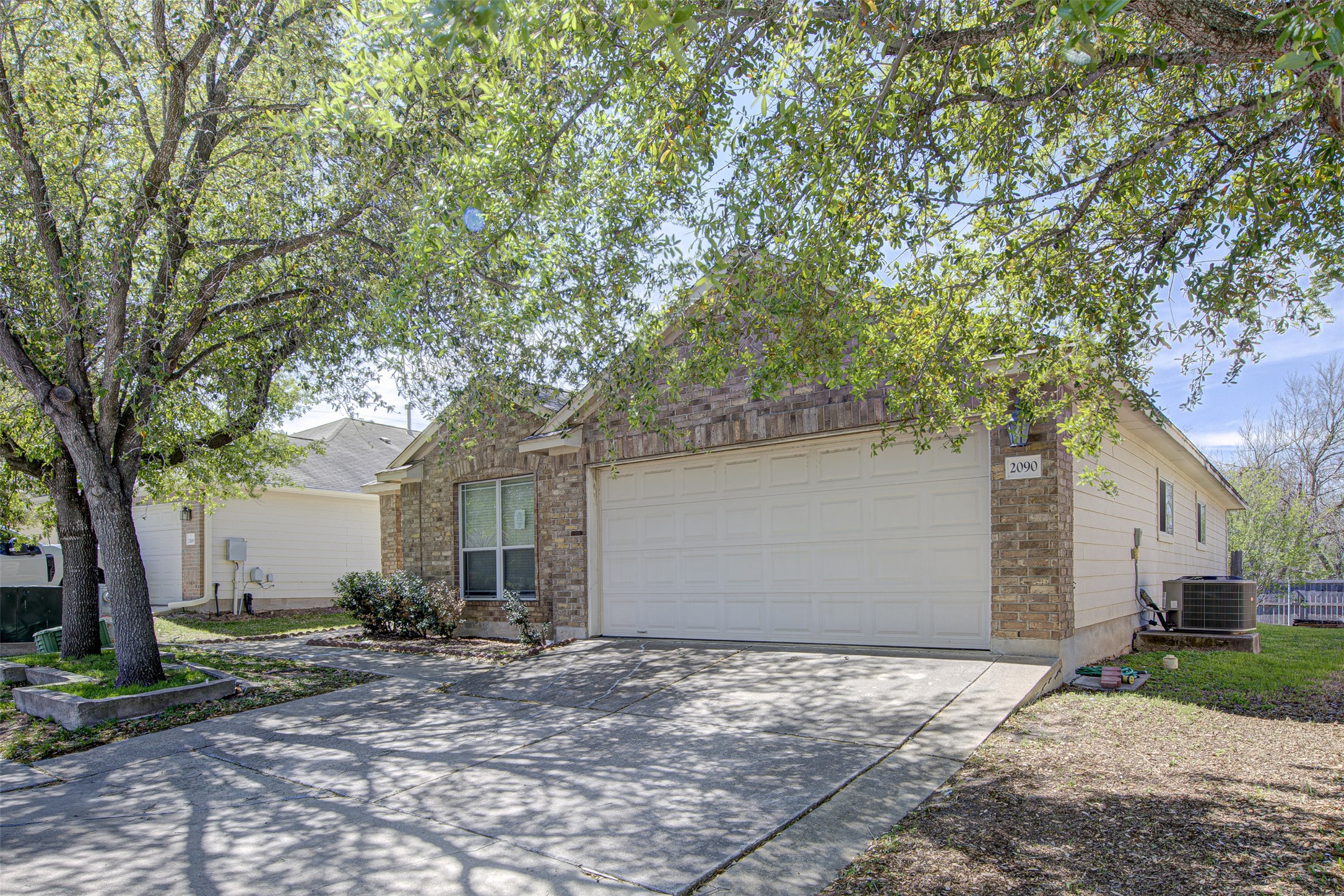 2090 Intrepid Drive Buda, TX 78610 - Photo 1 of 24 View of front of house featuring concrete driveway and an attached garage