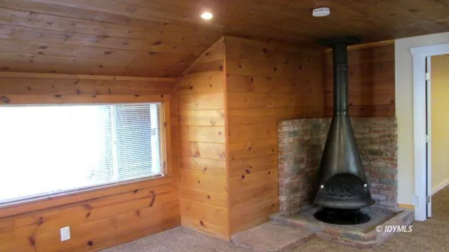 a front view of house with yard and trees around