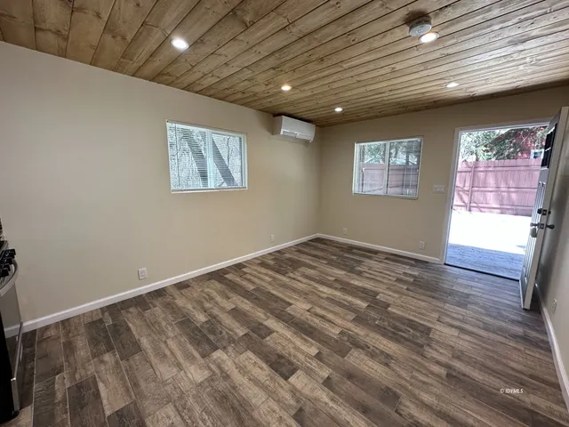 a room with wooden floors and windows
