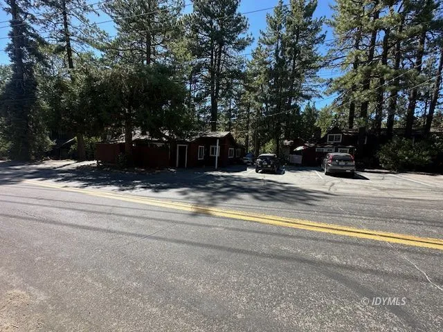 a view of a wooden fence under a large tree