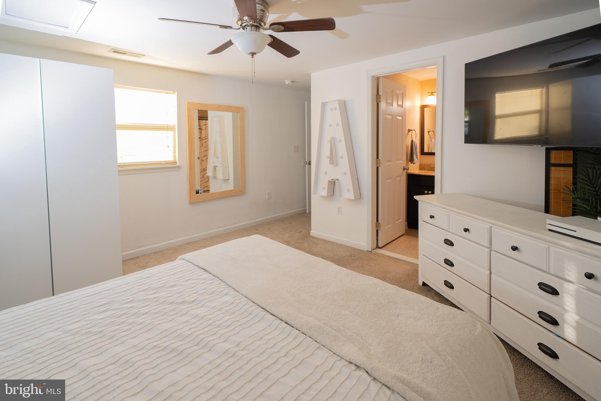 1816 Cremen Road Pasadena, MD 21122 - Photo 13 of 46 a spacious bedroom with a large bed and a flat tv screen on dresser