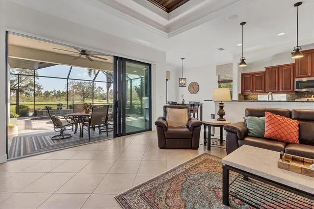 a dining room with furniture a chandelier and window