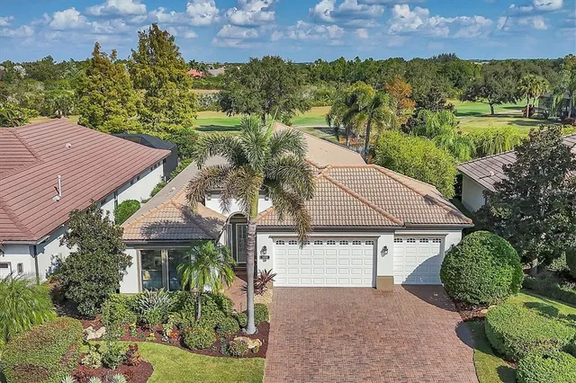 an aerial view of a house with a yard and a garden