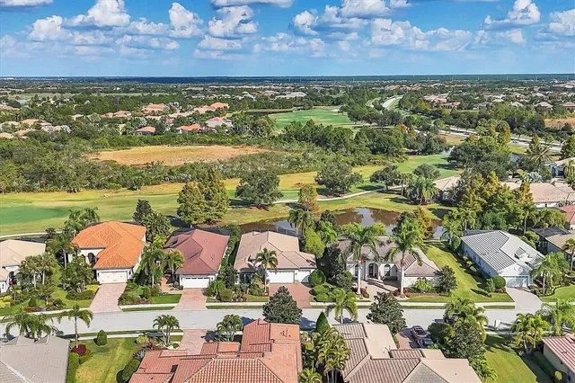a front view of a house with a garden and trees