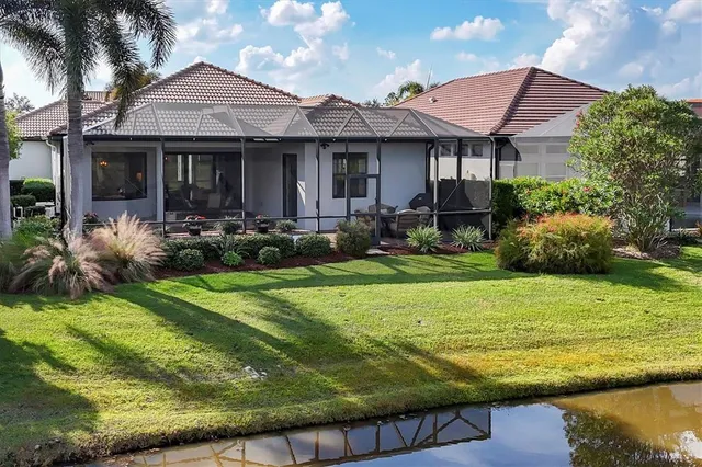 an aerial view of residential houses with outdoor space and swimming pool
