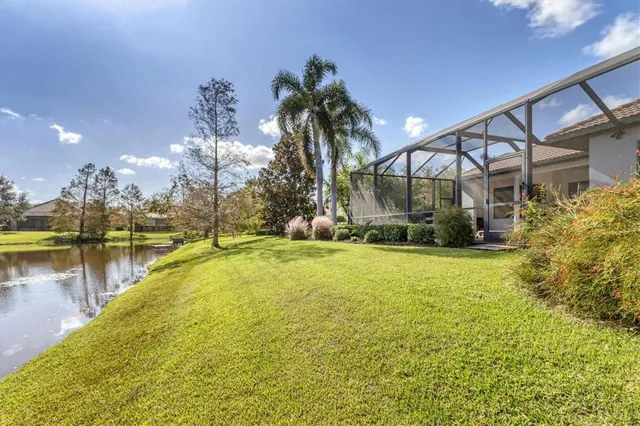 a front view of a house with a yard and mountain view