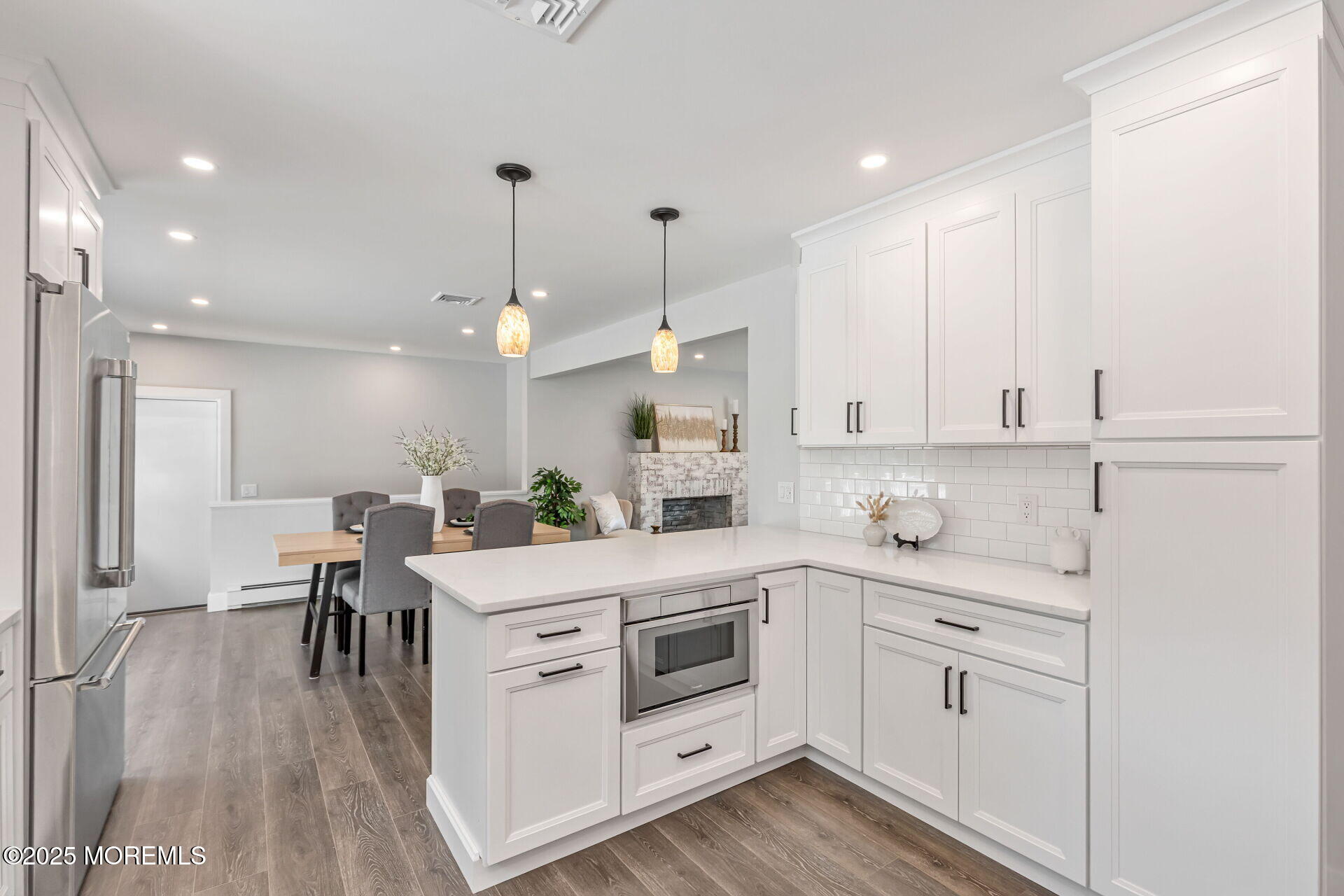 1276 West Front Street Lincroft, NJ 07738 - Photo 15 of 66 a kitchen with white cabinets stainless steel appliances and kitchen island