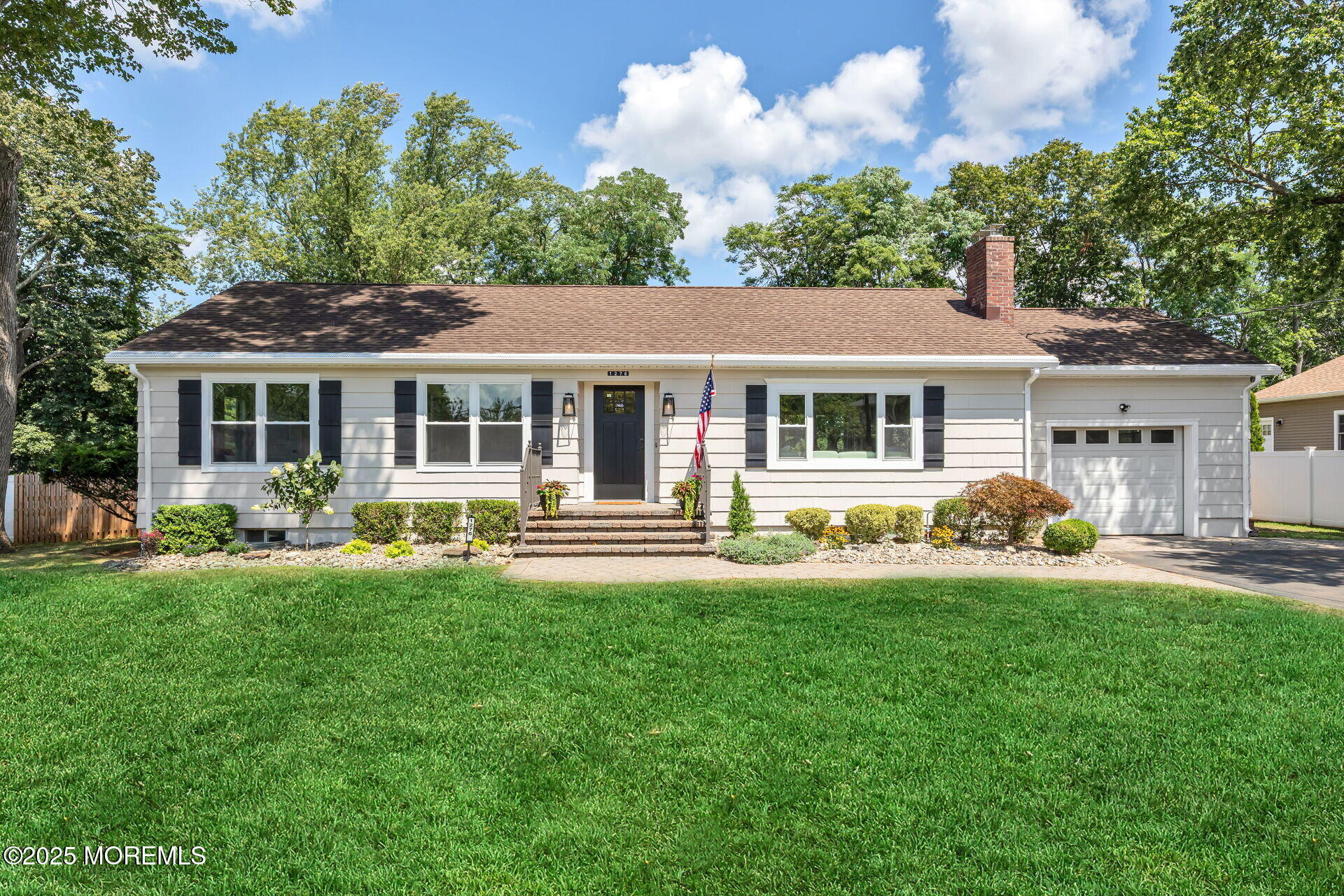 1276 West Front Street Lincroft, NJ 07738 - Photo 39 of 66 a front view of a house with a garden and trees