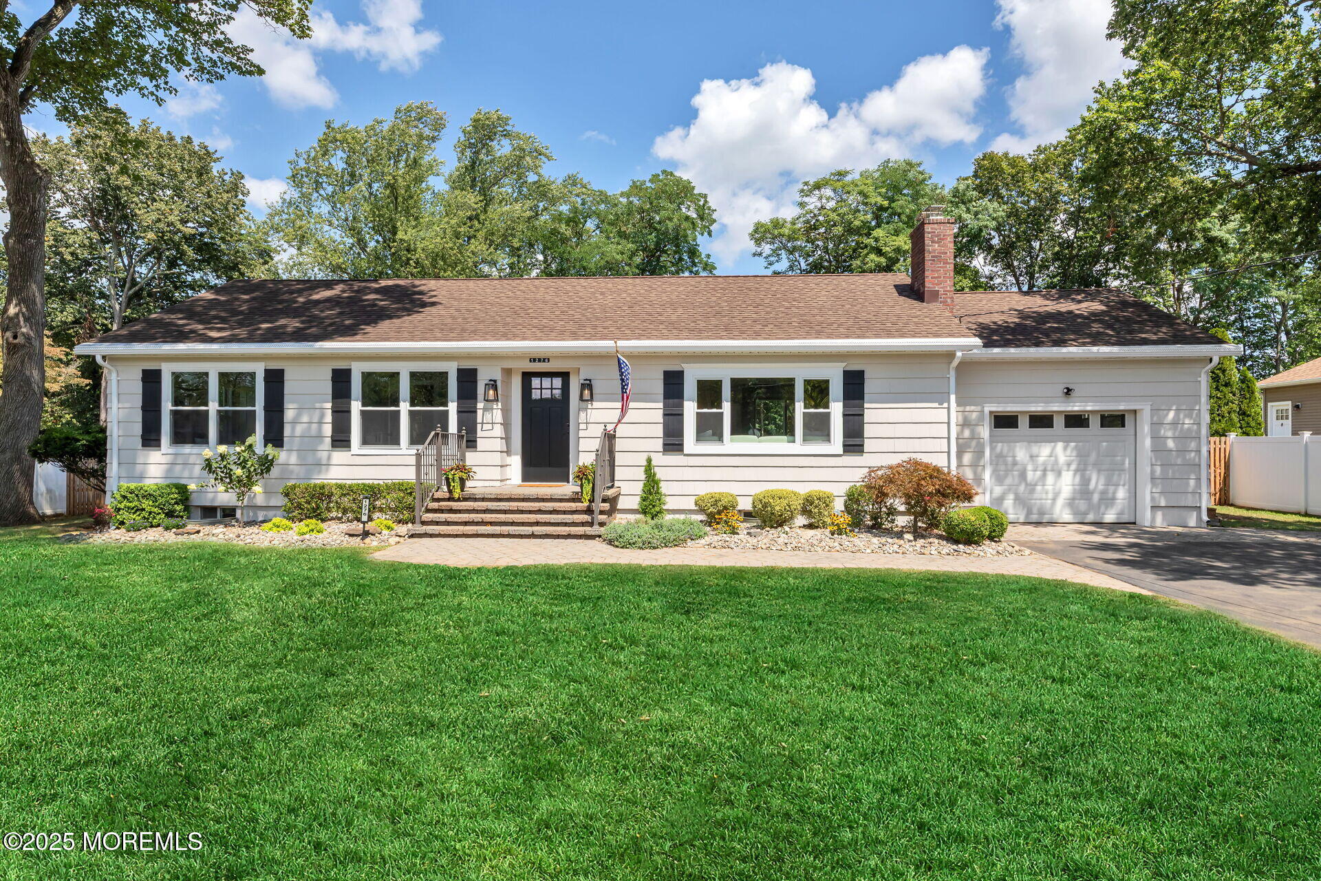 1276 West Front Street Lincroft, NJ 07738 - Photo 41 of 66 a front view of a house with a yard table and chairs