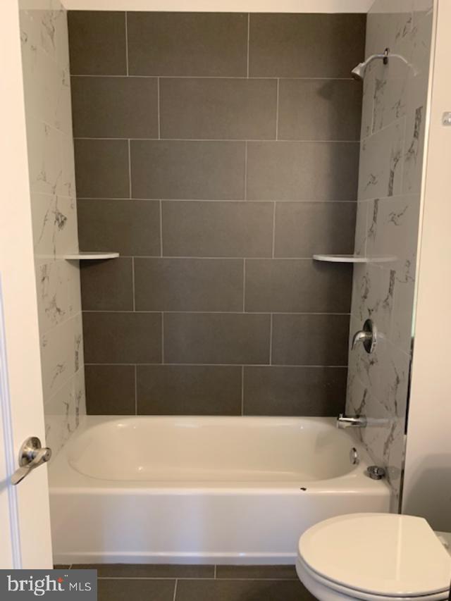 6162 Ridge Avenue, Unit 203 Philadelphia, PA 19128 - Photo 11 of 20 a bathroom with a toilet and bathtub