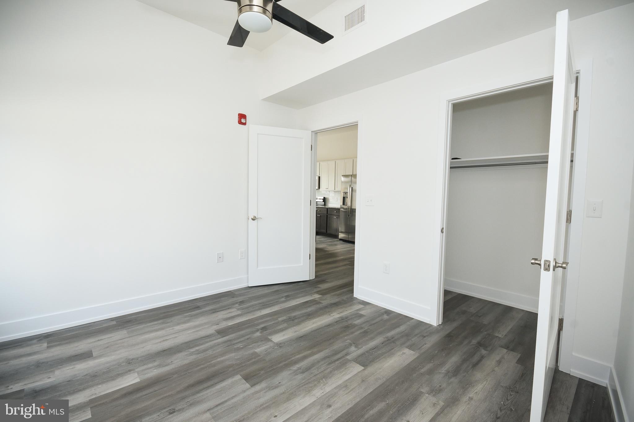 6162 Ridge Avenue, Unit 203 Philadelphia, PA 19128 - Photo 16 of 20 an empty room with wooden floor and windows