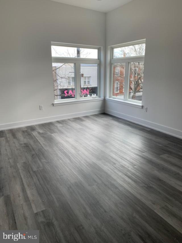6162 Ridge Avenue, Unit 203 Philadelphia, PA 19128 - Photo 8 of 20 an empty room with wooden floor and windows