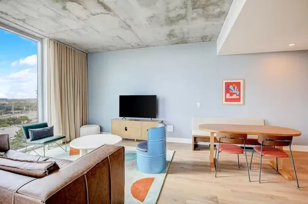 a living room with furniture and a flat screen tv