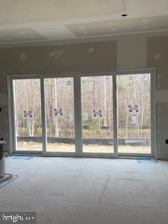 10417 Old Lawyers Road Unionville, VA 22567 - Photo 3 of 5 a view of a big room with wooden floor and a floor to ceiling window