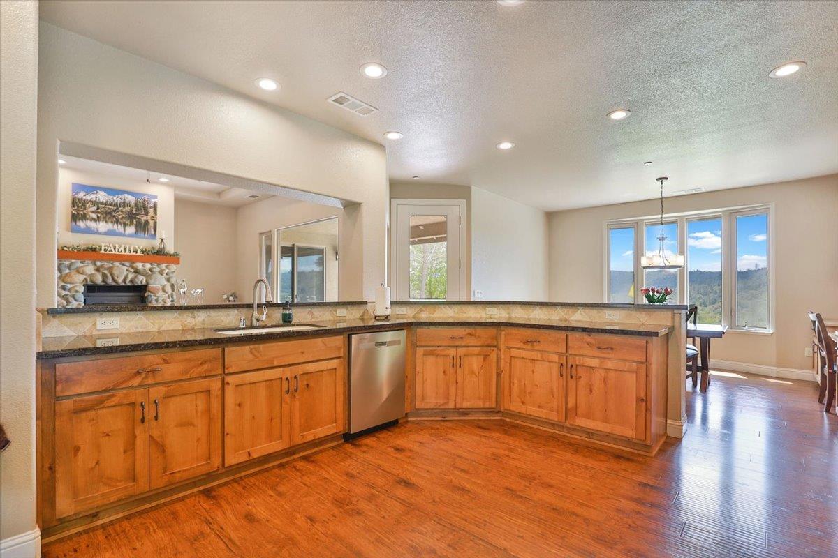 1111 Scott Road Lotus, CA 95651 - Photo 21 of 77 Striking dark granite countertops accent the gourmet kitchen.