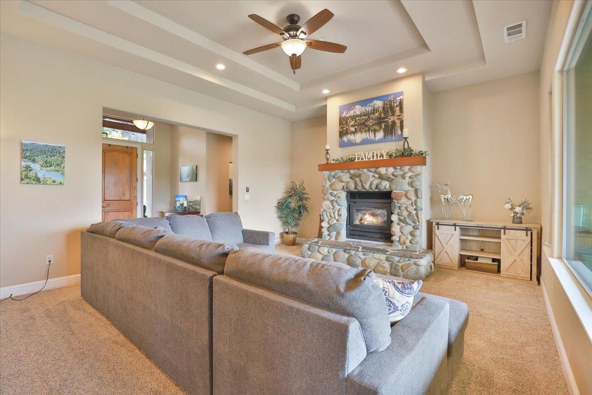 1111 Scott Road Lotus, CA 95651 - Photo 29 of 77 River rock fireplace is central in the great room.