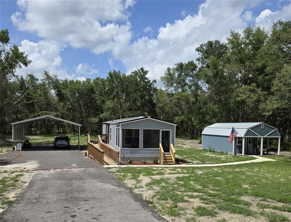 a view of a house with backyard and pool