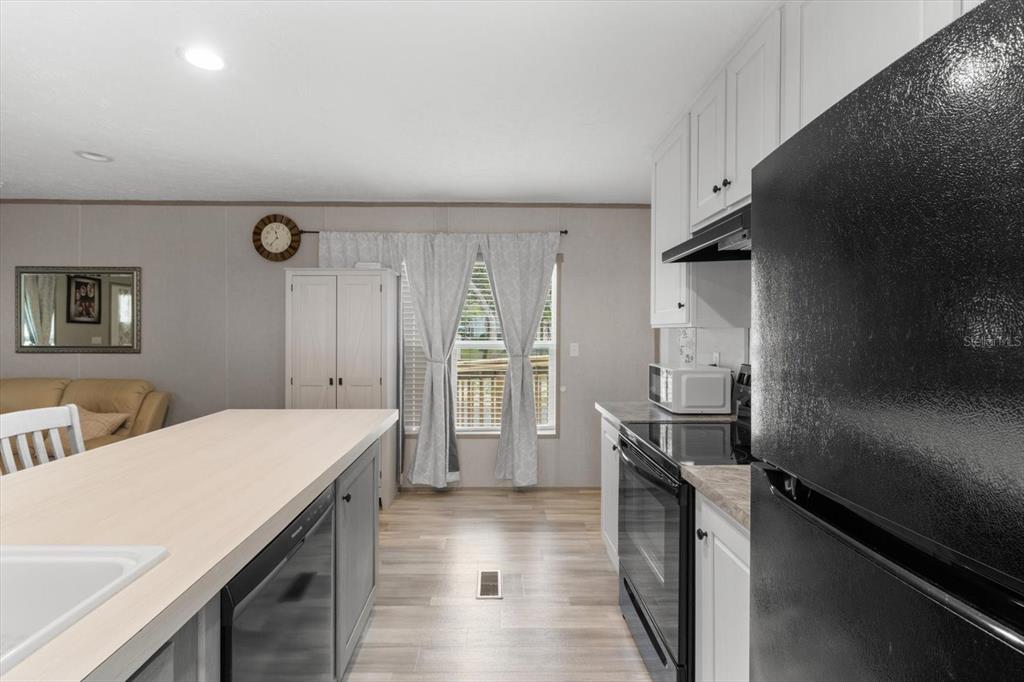 4686 C R 656 Webster, FL 33597 - Photo 12 of 32 a kitchen with a sink appliances and cabinets