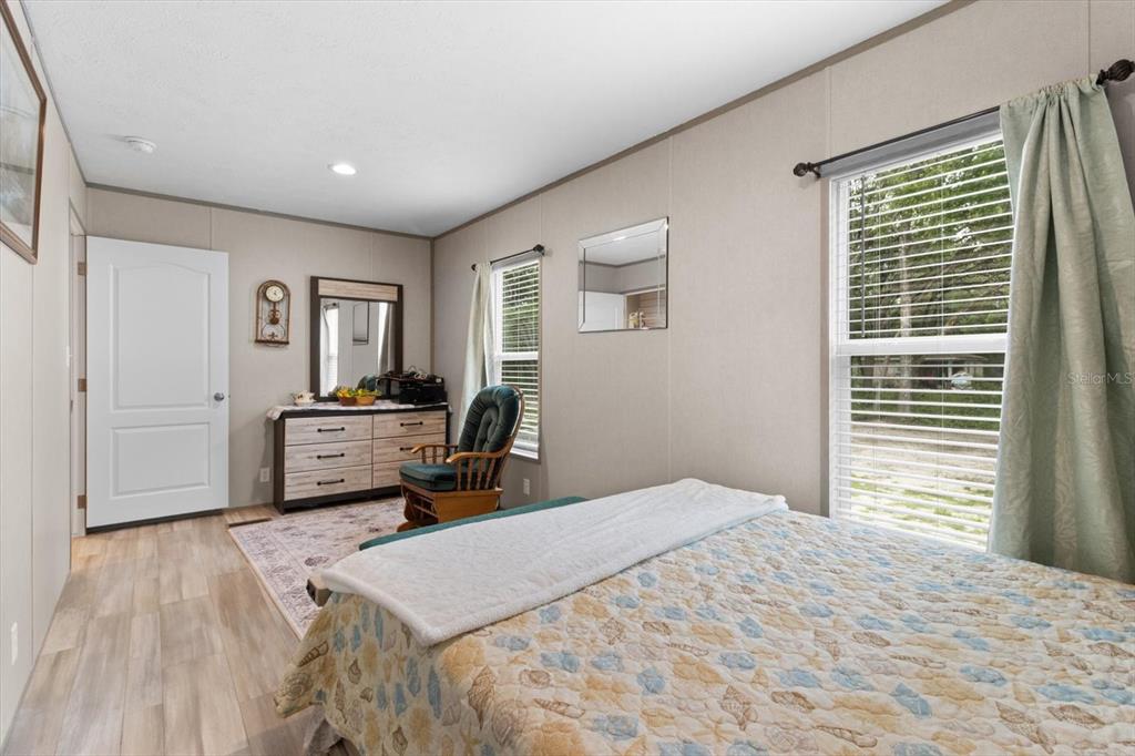 4686 C R 656 Webster, FL 33597 - Photo 16 of 32 a bedroom with a bed a mirror and a window