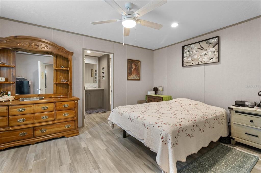 4686 C R 656 Webster, FL 33597 - Photo 18 of 32 a bed room with a bed and a chandelier