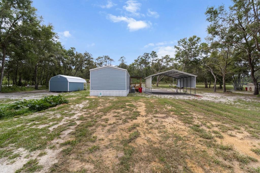 4686 C R 656 Webster, FL 33597 - Photo 28 of 32 a front view of a house with large garden and trees