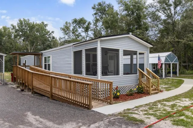 a view of a house with wooden fence