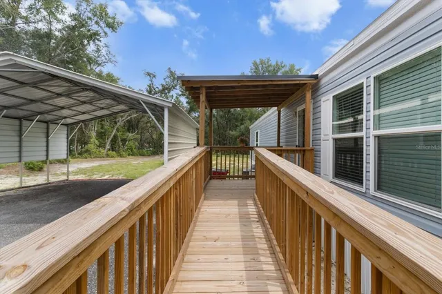 a view of balcony with wooden floor and fence