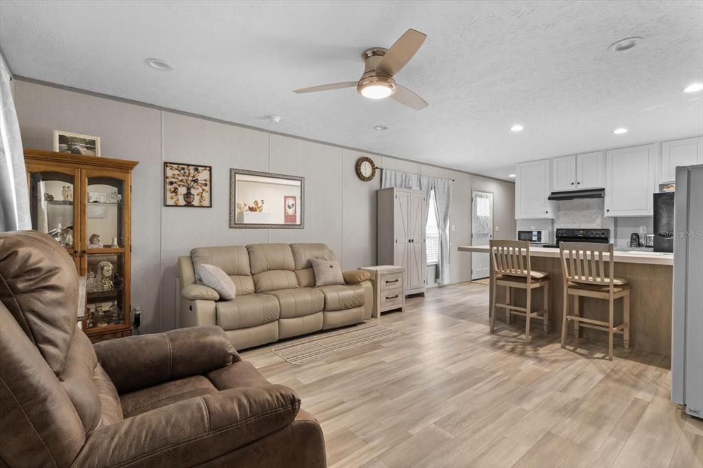 4686 C R 656 Webster, FL 33597 - Photo 7 of 32 a living room with furniture kitchen view and a wooden floor