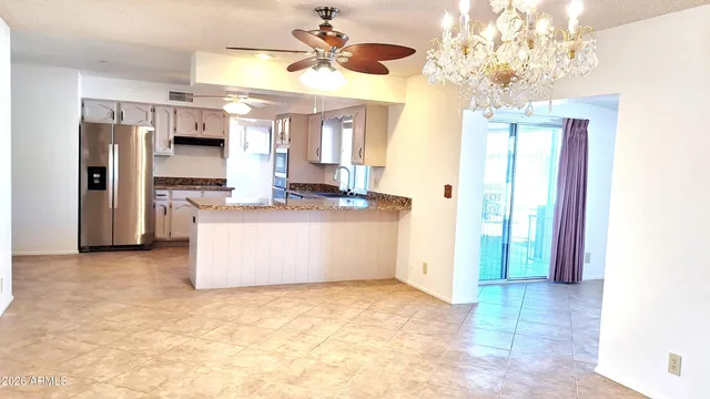 a view of a kitchen with a sink and a refrigerator